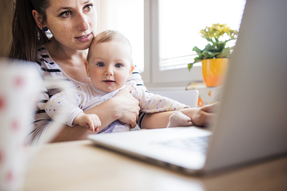 Woman Telecommuting - Working From Home Taking Care of Baby