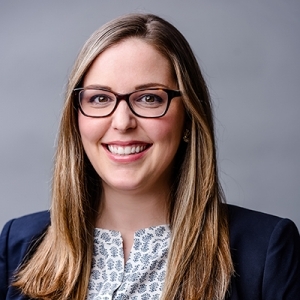 Smiling photo of attorney, Amy Boyle, in a professional suit against a gray background.