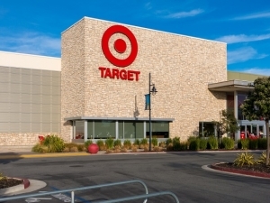 The facade of a Target store with the parking lot in the forefront.