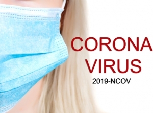 A close-up photo of a blond woman's face wearing a blue medical mask. Text reading: Corona Virus 2019-NCOV