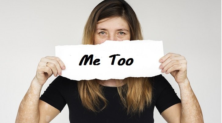 woman holding a me too poster