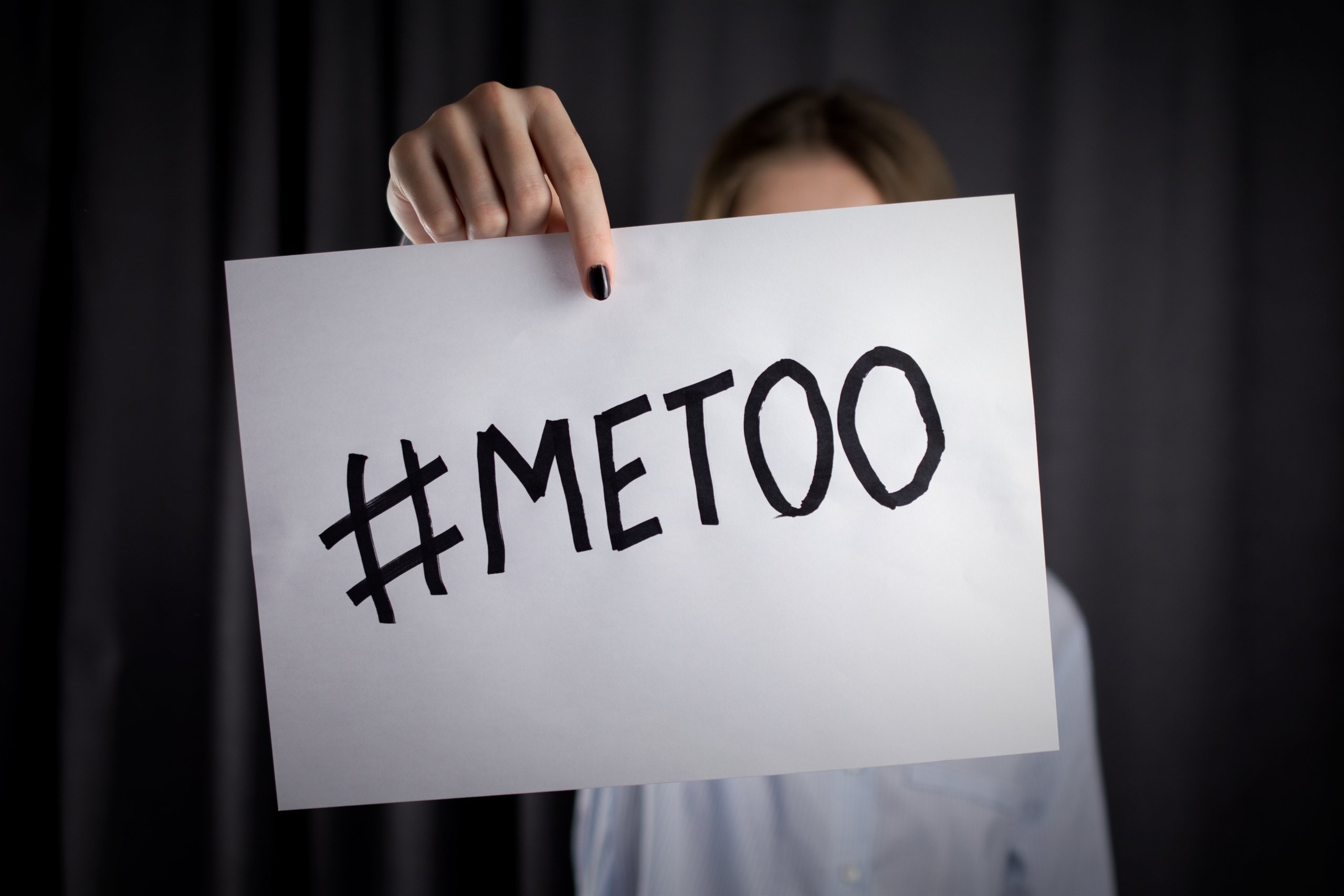 woman holding a hashtag me too sign