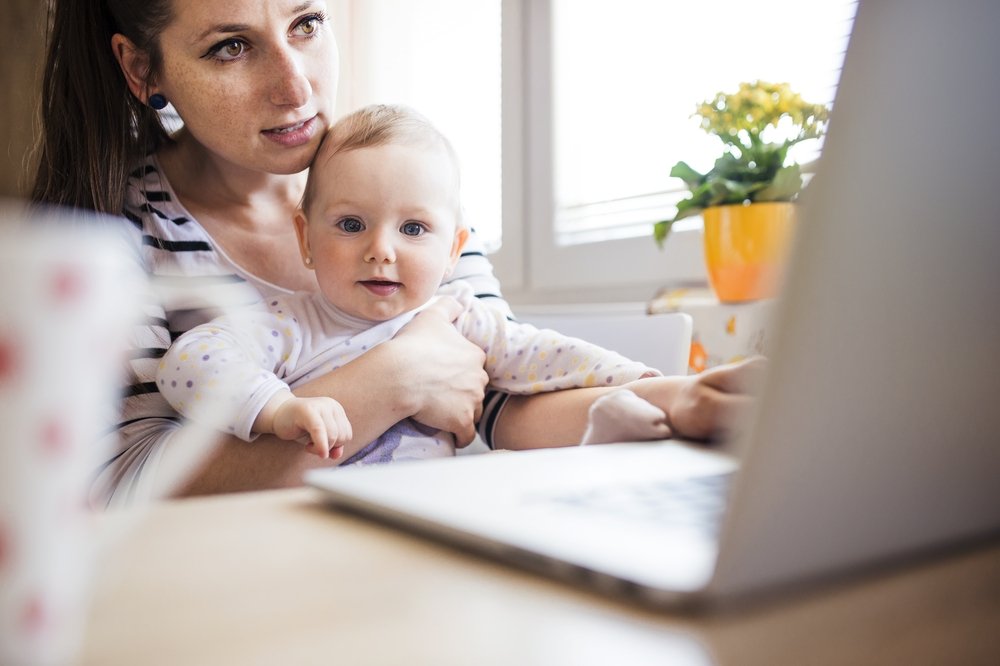 Woman Telecommuting – Working From Home Taking Care of Baby