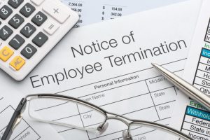 Close up of Employee termination form with pen and calculator