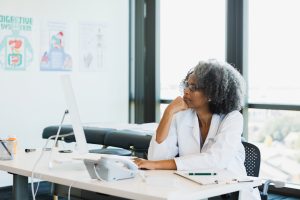 Female doctor looks over medical record for upcoming appointment